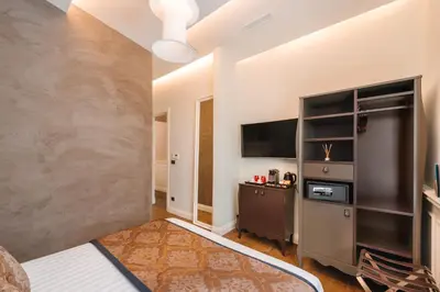 a hotel room with a bed and a television at DC Collection Spagna in Rome