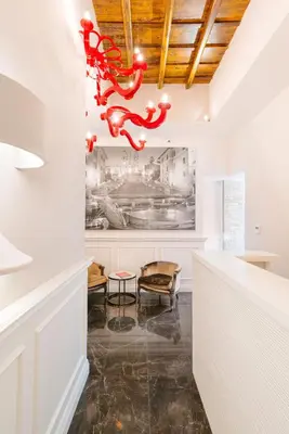 a living room with a chandelier hanging from the ceiling at DC Collection Spagna in Rome