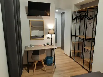 a room with a desk and a tv on the wall at Roman Residence in Rome