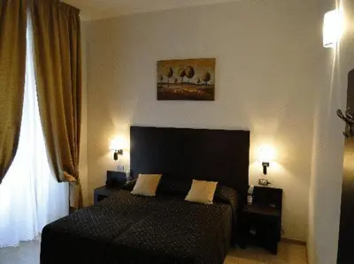 a bedroom with a black bed and a window at Roman Residence in Rome