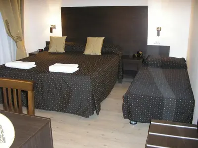 a hotel room with a bed and a table and chairs at Roman Residence in Rome