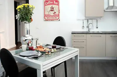 a white table with a plate of food on it in a kitchen at Rome Services Borgo Suites in Rome