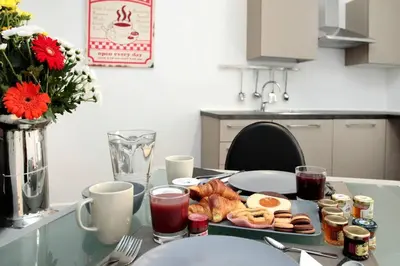 a table with a tray of breakfast foods on it at Rome Services Borgo Suites in Rome
