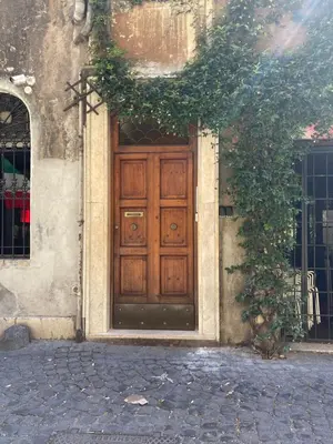 a wooden door on the side of a building at Madonna dei Monti in Rome