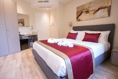 a bedroom with a large bed with towels on it at Leonardo Da Vinci Guest House in Rome
