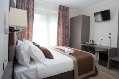 a bedroom with a large bed with a window at Leonardo Da Vinci Guest House in Rome