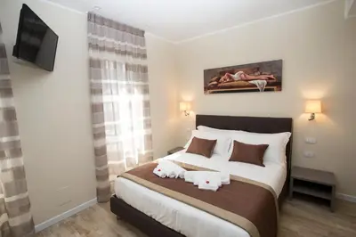 a bedroom with a bed with towels on it at Leonardo Da Vinci Guest House in Rome
