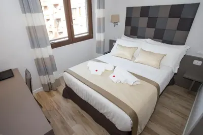 a bedroom with a large bed with two pillows at Leonardo Da Vinci Guest House in Rome