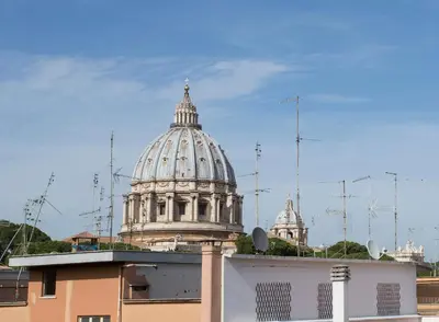 a domed building with a cathedral in the background at Leonardo Da Vinci Guest House in Rome
