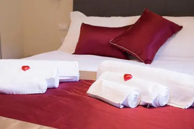 a bed with white towels and red hearts on it at Leonardo Da Vinci Guest House in Rome