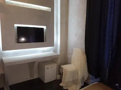 a living room with a tv on a wall at Glamour Spanish Steps in Rome