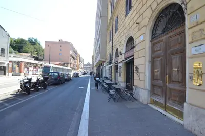 a person walking down a street next to a building at Glamour Spanish Steps in Rome
