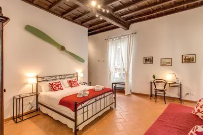 a bedroom with a bed and a desk in a room at Piccolo Trevi Suites in Rome