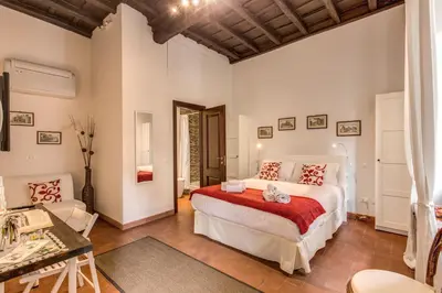 a bedroom with a bed and a living room at Piccolo Trevi Suites in Rome