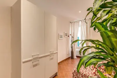 a room with a plant and a white cabinet at Piccolo Trevi Suites in Rome