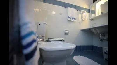 a bathroom with a white toilet and a sink at Residenza Matilde in Rome