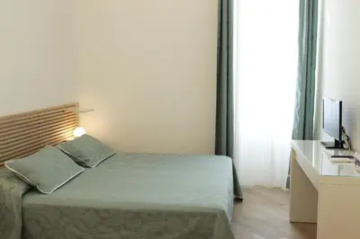 a hotel room with a bed and a television at B&B Roma Olimpic in Rome