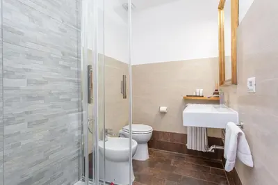 a bathroom with a toilet and a sink and a shower at Easybnb - Dea Roma in Rome