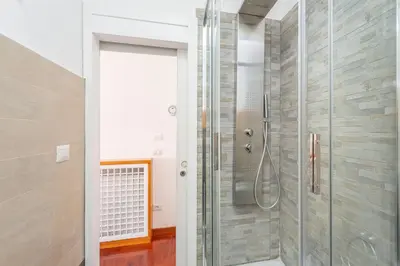 a shower with a glass door in a bathroom at Easybnb - Dea Roma in Rome
