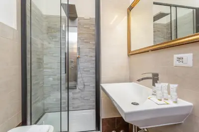 a bathroom with a sink and a shower at Easybnb - Dea Roma in Rome