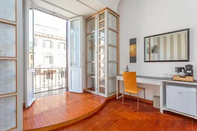 a room with a desk with a chair and a window at Easybnb - Dea Roma in Rome