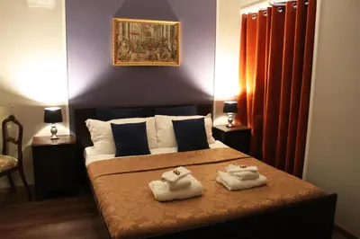 a bedroom with a bed with two towels on it at Raphael Rooms in Rome