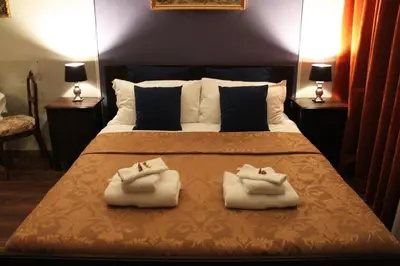 a bedroom with a bed with two towels on it at Raphael Rooms in Rome