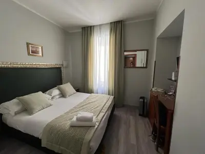 a hotel room with a bed and a window at Hotel Ercoli House in Rome
