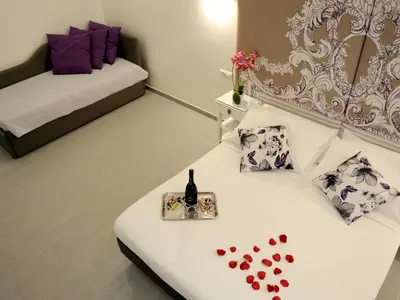a room with a white bed with hearts on it at Easyrome Guest House in Rome