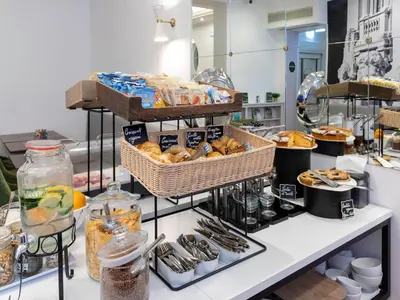 a bakery counter with baskets of bread and other food at B&B Hotel Roma Italia Viminale in Rome