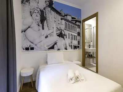 a bedroom with a white bed and a mirror at B&B Hotel Roma Italia Viminale in Rome