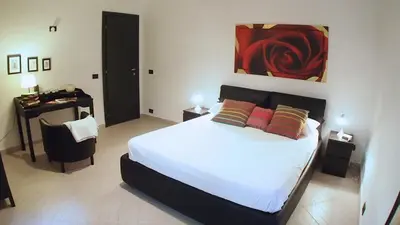 a bedroom with a bed and a desk in a room at La Piazzetta di Roma in Rome