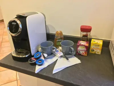 a coffee maker and two cups on a counter at La Piazzetta di Roma in Rome