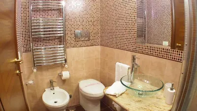 a bathroom with a toilet and a glass sink at La Piazzetta di Roma in Rome
