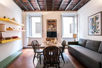 a living room with a table and chairs and a couch at Dell'Orso Residence in Rome