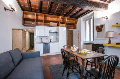 a kitchen and a living room with a table and a couch at Dell'Orso Residence in Rome