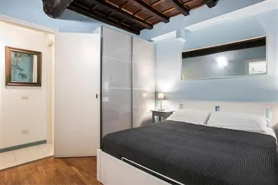 a bedroom with a bed and a glass wall at Dell'Orso Residence in Rome