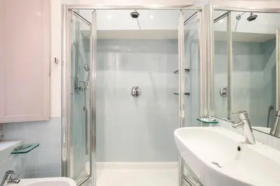 a bathroom with a glass shower and a sink at Dell'Orso Residence in Rome