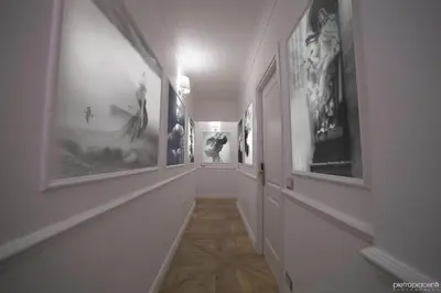 a hallway with many pictures on the walls at Vatican Luxury Home in Rome