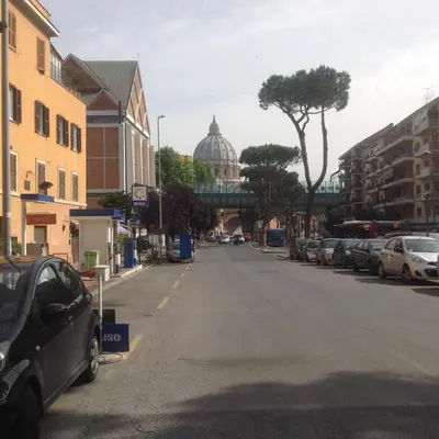 an empty street with cars parked on the side of the road at Vatican Luxury Home in Rome