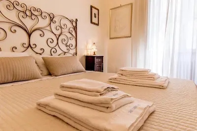 a bedroom with a bed with towels on it at Sant'Ivo Apartments in Rome