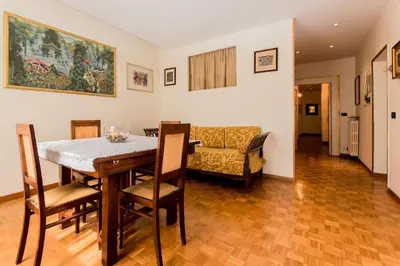 a dining room with a table and chairs and a couch at Sant'Ivo Apartments in Rome