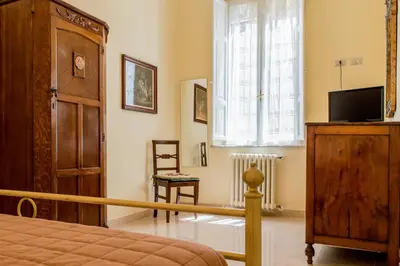 a bedroom with a bed and a tv and a window at Sant'Ivo Apartments in Rome