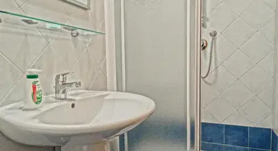 a bathroom with a sink and a shower at Gite House in Rome
