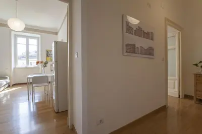 a white room with a bed and a window at Vatican Suite Carolina Holiday Apartment in Rome