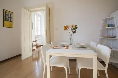 a kitchen and living room with a couch and a table at Vatican Suite Carolina Holiday Apartment in Rome