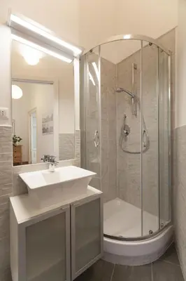 a white bedroom with a bed and a window at Vatican Suite Carolina Holiday Apartment in Rome