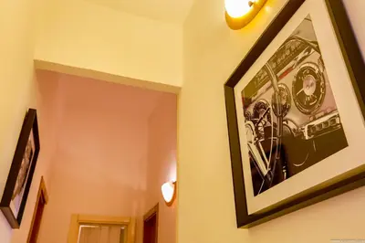 a picture hanging on a wall in a hallway at Gordon's Apartment in Rome