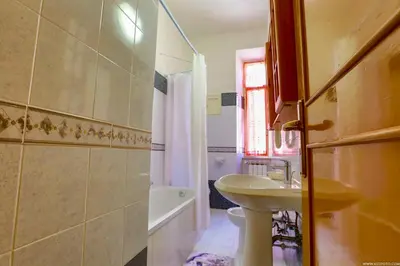 a bathroom with a sink and a toilet and a tub at Gordon's Apartment in Rome