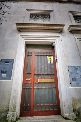 a red door on the side of a building at Gordon's Apartment in Rome